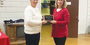 Photograph of Lena Custer presenting Janna Blosser with the award for Ruritan of the Year.