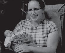 Photograph of Sarah Witmer holding a baby.
