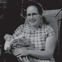 Photograph of Sarah Witmer holding a baby.