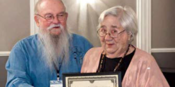 ASV President Mike Barber presents the Avocational Archeologist of the Year 2022 award to Janice Biller. (Photo credit: Terri Aigner, ASV webmaster)