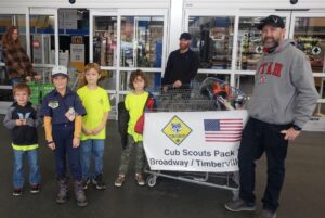 Boy scouts and parents at a food drive.