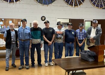 Veterans stand at a town ceremony.