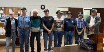 Veterans stand at a town ceremony.