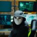 masked hacker at computers.