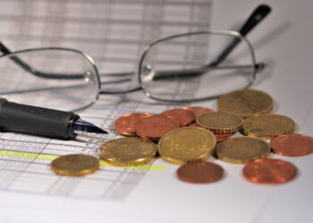 Coins and glasses on a table.
