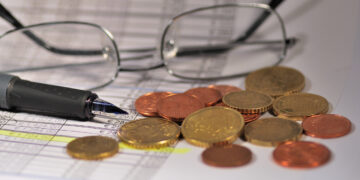 Coins and glasses on a table.