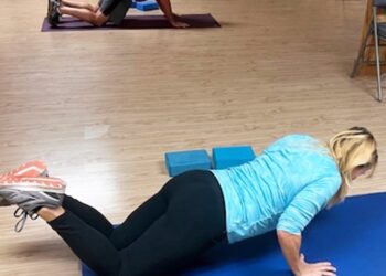 Two people working out in a room.
