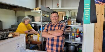 Man standing in a restaurant.