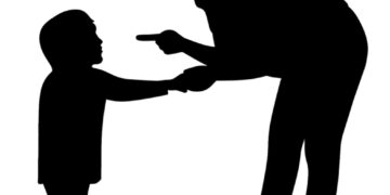 Silhouette of a child and man.