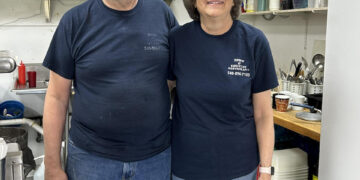 Two people in a restaurant kitchen.