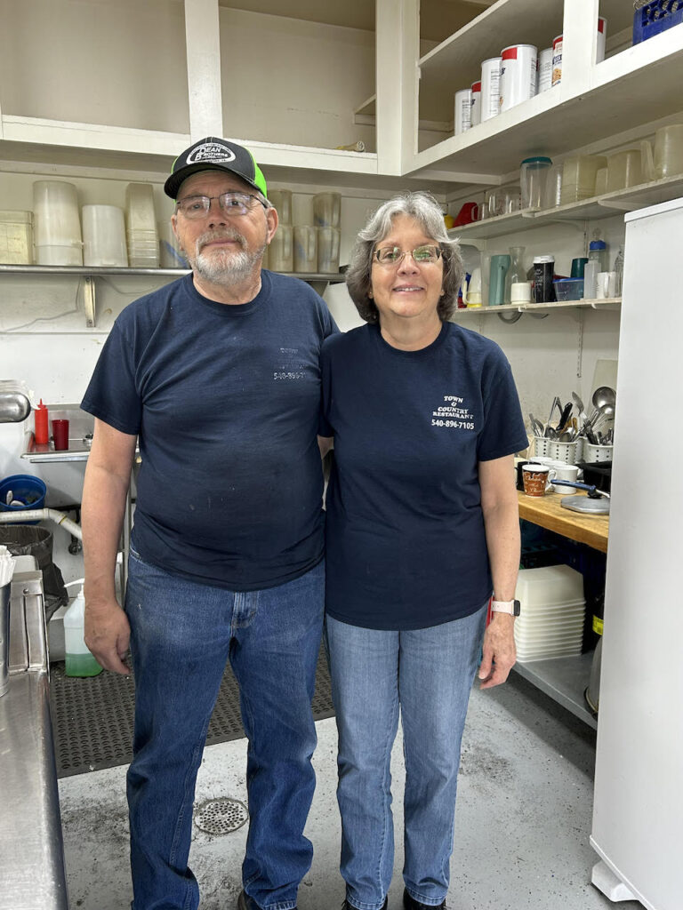 Two people in a restaurant kitchen.