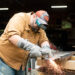 Man cutting metal.